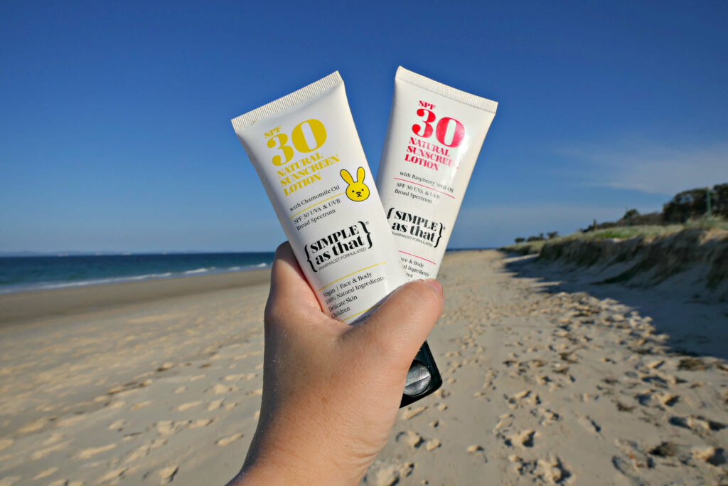 Bottles of Simple as That Zinc sunscreen Australia on a beach