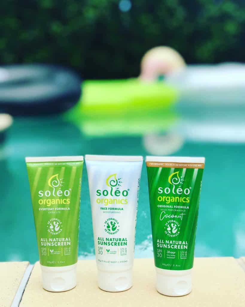 Bottles of Soleo Sunscreen Australia by a pool